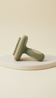 Ergonomic grooming brush, use a 3/4 angle to capture the ergonomic design of the products on a clean, natural surface like...